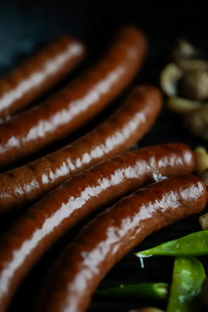 Delicious grilled sausages with green peppers and mushrooms, perfect for a tasty BBQ.